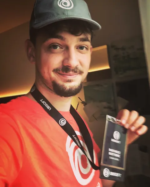 Raffaele Bottone alla Gamescom 2018 con il cappellino e il pass di Ubisoft